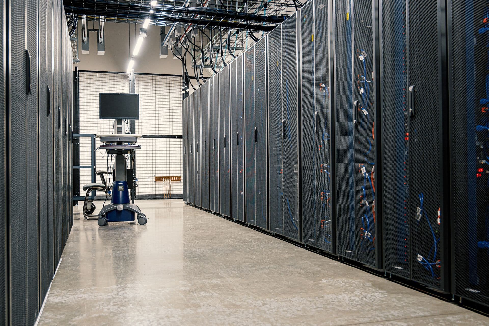 Data center aisle with rows of active server racks