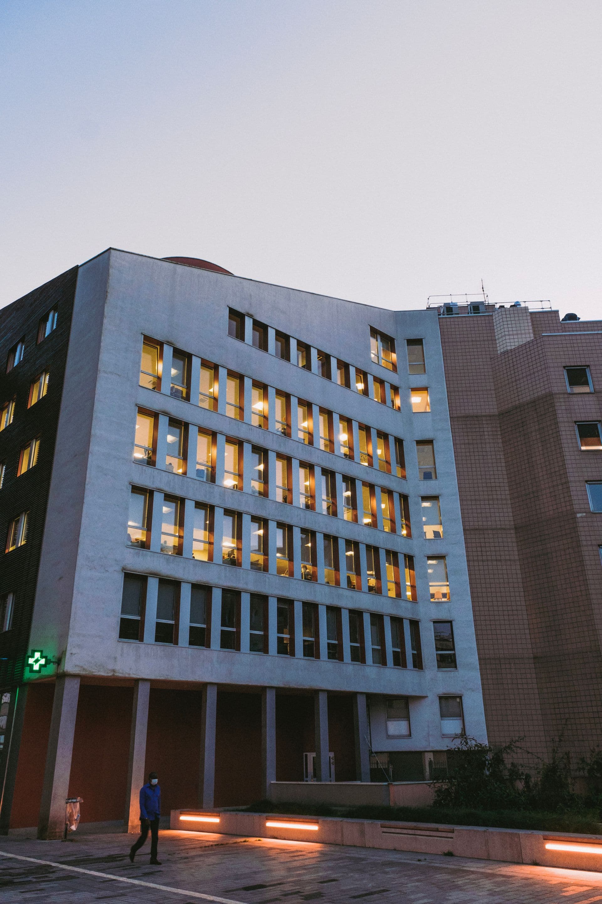 Modern healthcare facility building exterior at dusk
